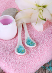 Beautiful spa setting with lily on wooden table close-up