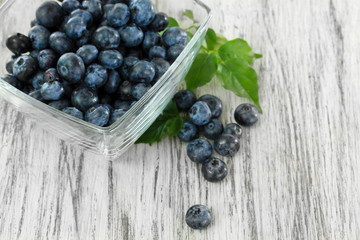 Blueberries in glass bowl on wooden table