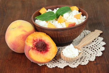 Naklejka na ściany i meble Sour cheese and fresh peaches,on wooden table background