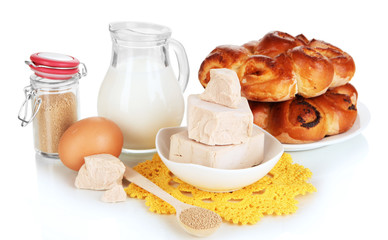 Dry yeast with pastry and baking ingredients isolated on white