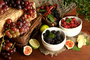 Assortment of juicy fruits and berries on wooden background