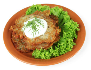 Potato pancakes on plate, isolated on white