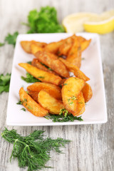 Home potatoes on plate on napkin wooden table