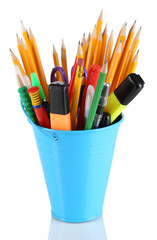 Colorful pencils and other art supplies in pail isolated