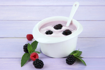 Delicious yogurt with berries on table close-up