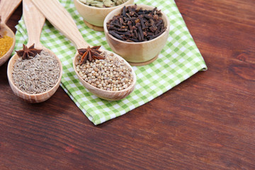 Various spices and herbs on wooden background