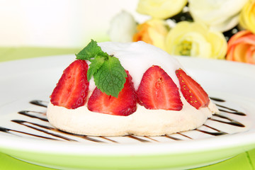 Tasty meringue cake with berries on green wooden table