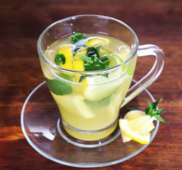 Cup of tea with ginger on wooden table