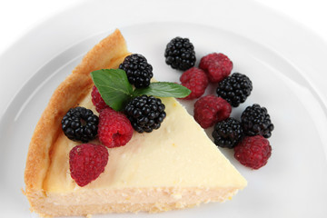 Slice of cheesecake  with berries and sauce