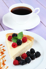 Slice of cheesecake with raspberry and blackberry