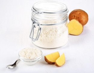 Starch in bowl and bank on wooden table close-up