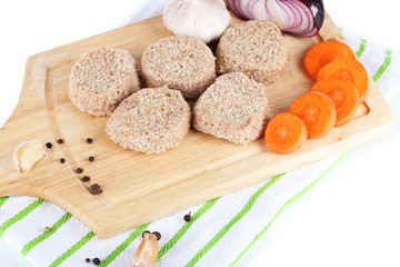 Meat patties on board on napkin  isolated on white