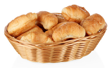 Tasty croissants in wicker basket isolated on white