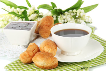 Tasty croissants and cup of coffee close-up