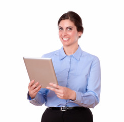 Charming young woman standing using tablet pc