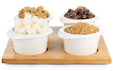 Different types of sugar in bowls isolated on white