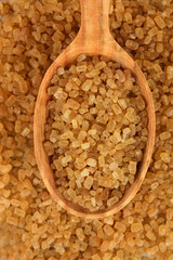Brown sugar in spoon close-up