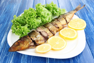 Smoked fish on plate close up