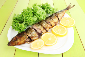 Smoked fish on plate close up