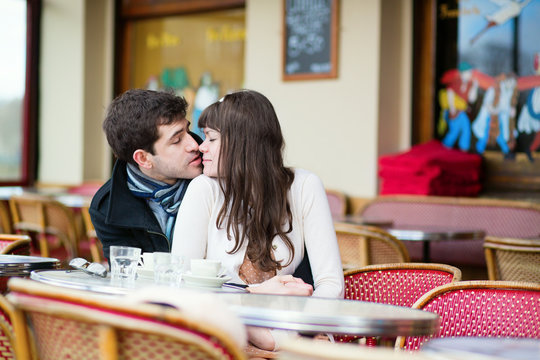 Dating couple kissing in a cafe