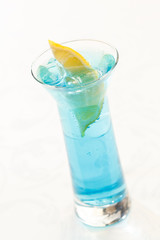 blue cocktail with lemon
