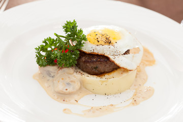 fried egg with steak and potatoes
