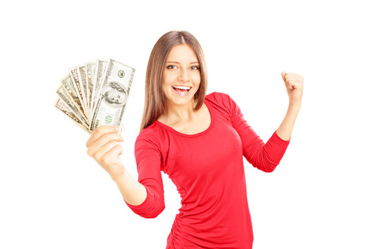 Happy female holding US dollars and gesturing happiness