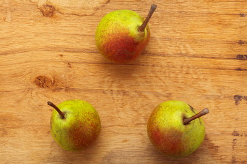 Three pears fruits on wooden table background
