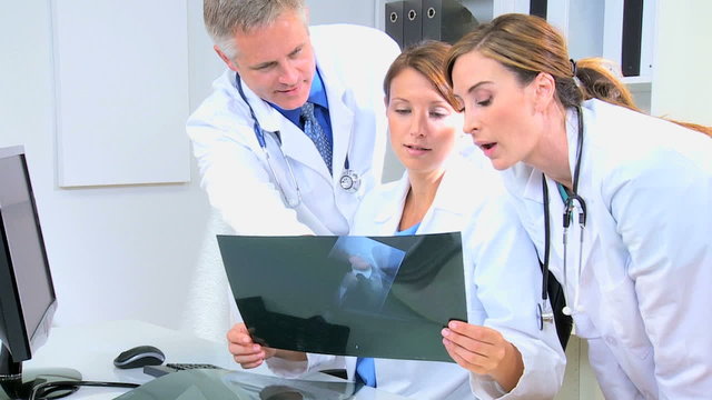 Medical Colleagues Checking Patient X-Rays Close Up
