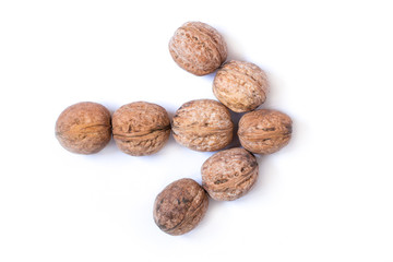 Arrow made of nuts isolated on white background