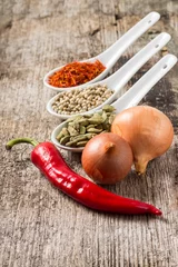 Foto op Aluminium Background with Spices and Vegetables on wood plank © skumer