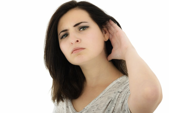 Beautiful and attractive girl listening gesture over a white bac