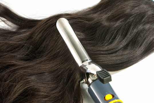 Electric Curling Iron And Hair On White Background