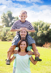 Portrait of happy couple together with teenager