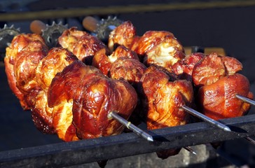 grilling pork meat upon glowing embers