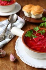 red soup with bread rolls