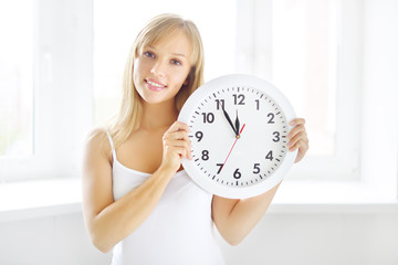 smiling girl with wall clock