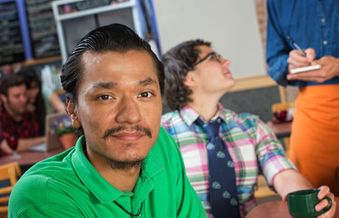 Handsome Asian Man in Cafe