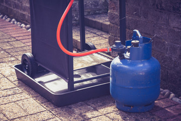 Gas canister and portable barbecue - obrazy, fototapety, plakaty