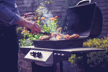 Man cooking meat on barbecue