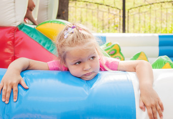 little girl played enough and waiting parents.