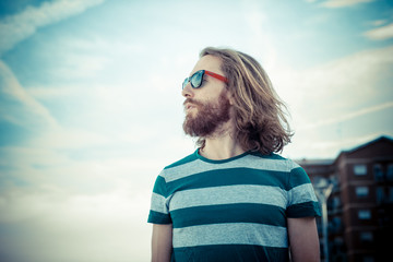 stylish hipster model with long red hair and beard lifestyle