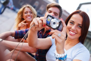 Group of friends with photo camera outdoors