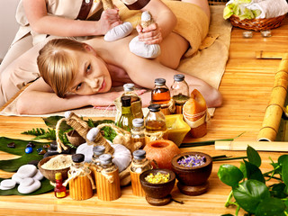 Obraz na płótnie Canvas Woman getting herbal ball massage .