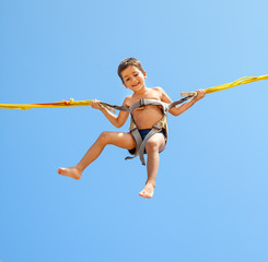 Boy jumping on trampoline