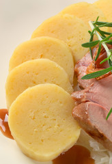 Pork with potato dumplings and white cabbage
