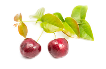 Ripe cherry berries with green leaf isolated on white background