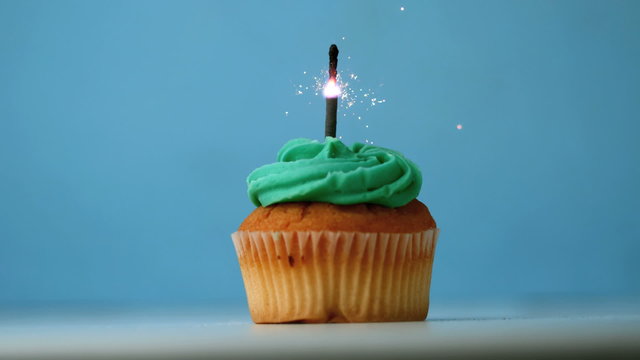 Sparkler burning on a birthday cupcake