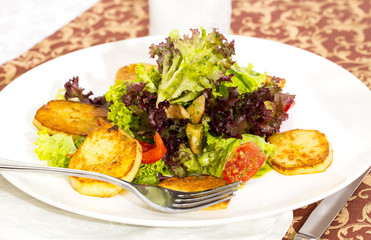 salad of mushrooms and potatoes on the table in a restaurant
