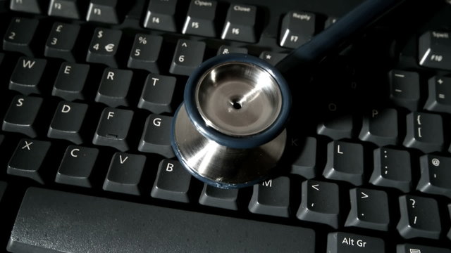 Stethoscope falling onto computer keyboard and bouncing
